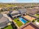 This property boasts a modern pool, vibrant green lawn, and low-maintenance desert landscaping at 8754 W San Juan Ave, Glendale, AZ 85305