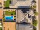 A modern pool, well-manicured lawn, and the roof's solar panels are viewed from above at 8754 W San Juan Ave, Glendale, AZ 85305