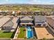 This backyard oasis has a modern pool, lush landscaping, and views of a nearby golf course at 8754 W San Juan Ave, Glendale, AZ 85305