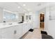 Bright bathroom featuring dual sinks, large mirror, and a walk-in closet at 8754 W San Juan Ave, Glendale, AZ 85305