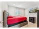 Bedroom featuring a red bed, modern art, and shuttered windows at 8754 W San Juan Ave, Glendale, AZ 85305