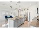 Open kitchen flows into living and dining area, featuring an island with sink and stainless steel appliances at 8754 W San Juan Ave, Glendale, AZ 85305