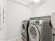 Laundry room with front load washer and dryer and overhead storage at 8754 W San Juan Ave, Glendale, AZ 85305