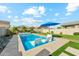 Backyard pool area featuring a luxurious pool, lounge chairs, and a vibrant blue umbrella at 8754 W San Juan Ave, Glendale, AZ 85305