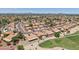 Expansive aerial view of a well-maintained community with red-tiled roofs and lush green golf course fairways at 9263 W Oraibi Dr, Peoria, AZ 85382