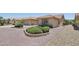 Desert landscaping and mature shrubbery in this low maintenance front yard at 9263 W Oraibi Dr, Peoria, AZ 85382
