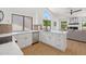 Stylish kitchen featuring quartz countertops, white cabinets, and a view to the outdoor space at 9263 W Oraibi Dr, Peoria, AZ 85382