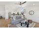 Bright, open-concept living space with contemporary decor, modern lighting, and seamless flow to the kitchen at 9263 W Oraibi Dr, Peoria, AZ 85382