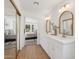 Elegant main bathroom with dual vanity sinks, updated fixtures, and bright natural lighting at 9263 W Oraibi Dr, Peoria, AZ 85382