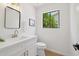 Modern powder room with sleek vanity, contemporary fixtures, and a window for natural light at 9263 W Oraibi Dr, Peoria, AZ 85382