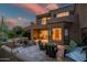 Expansive back patio with outdoor seating, a fire pit, grill, and a beautiful sunset view at 9270 E Thompson Peak Pkwy # 347, Scottsdale, AZ 85255