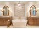 Luxurious bathroom with a freestanding tub, dual vanities, and decorative mirrors creating a spa-like retreat at 9270 E Thompson Peak Pkwy # 347, Scottsdale, AZ 85255