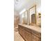 Elegant bathroom with double vanity, marble countertops, gold-framed mirrors, and glass shower at 9270 E Thompson Peak Pkwy # 347, Scottsdale, AZ 85255