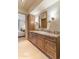 Bathroom featuring marble countertops, wooden drawers, and view into the bedroom at 9270 E Thompson Peak Pkwy # 347, Scottsdale, AZ 85255