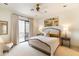 Bright bedroom featuring a ceiling fan, painting, and a door to the balcony at 9270 E Thompson Peak Pkwy # 347, Scottsdale, AZ 85255