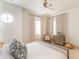Cozy bedroom with a round window, comfortable chair, chest of drawers, and natural light at 9270 E Thompson Peak Pkwy # 347, Scottsdale, AZ 85255