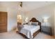 This bedroom includes a ceiling fan, a beautiful bed, carpet and ensuite bathroom at 9270 E Thompson Peak Pkwy # 347, Scottsdale, AZ 85255