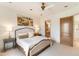 Well lit bedroom with a ceiling fan and view into the bathroom at 9270 E Thompson Peak Pkwy # 347, Scottsdale, AZ 85255