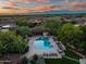Beautiful community pool with lounge chairs and desert views at sunset at 9270 E Thompson Peak Pkwy # 347, Scottsdale, AZ 85255