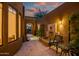 Charming courtyard view featuring a tiled fountain, seating, and an arched entryway at 9270 E Thompson Peak Pkwy # 347, Scottsdale, AZ 85255