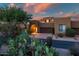 Inviting desert home featuring a charming entrance, two-car garage, and beautiful desert landscaping at 9270 E Thompson Peak Pkwy # 347, Scottsdale, AZ 85255