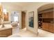 Bright hallway leading to the main bedroom, showcasing a modern vanity and stylish storage solutions at 9270 E Thompson Peak Pkwy # 347, Scottsdale, AZ 85255
