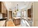 Bright, open kitchen with marble counters, wood cabinets, island seating, and access to a private patio at 9270 E Thompson Peak Pkwy # 347, Scottsdale, AZ 85255