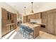 Spacious kitchen featuring a large island, wood cabinets, and stainless steel appliances at 9270 E Thompson Peak Pkwy # 347, Scottsdale, AZ 85255