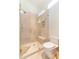 Luxurious glass shower with built-in bench and shelf, accented with gold fixtures and neutral tile at 9270 E Thompson Peak Pkwy # 347, Scottsdale, AZ 85255