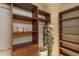 Organized walk-in closet with custom shelving, hanging rods, and a designated area for accessories at 9270 E Thompson Peak Pkwy # 347, Scottsdale, AZ 85255