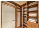 Spacious walk-in closet with custom wood shelving and ample storage for clothes and accessories at 9270 E Thompson Peak Pkwy # 347, Scottsdale, AZ 85255