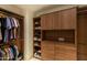 This walk-in closet boasts wood cabinetry, shelving, hanging rods, and plenty of storage at 9270 E Thompson Peak Pkwy # 347, Scottsdale, AZ 85255