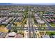 Aerial view showcases neatly planned streets and residential homes, highlighted by palm tree accents and landscaped medians at 9624 E Thunderbolt Ave, Mesa, AZ 85212