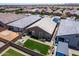 Wide aerial shot showing a landscaped backyard, outdoor living space, and the surrounding neighborhood at 9624 E Thunderbolt Ave, Mesa, AZ 85212