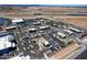 Aerial view showcases commercial properties with ample parking, nearby highway access, and landscaping in the surrounding area at 9624 E Thunderbolt Ave, Mesa, AZ 85212