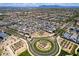Wide aerial shot captures a well-planned community with manicured landscapes, roundabouts, and neat rows of single-Gathering homes at 9624 E Thunderbolt Ave, Mesa, AZ 85212