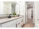 The bathroom features a dual sink vanity, white cabinetry, and modern black fixtures at 9624 E Thunderbolt Ave, Mesa, AZ 85212