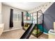 This bedroom features a bunk bed with a slide and creative painted geometric designs on the walls at 9624 E Thunderbolt Ave, Mesa, AZ 85212
