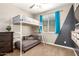 Charming bedroom featuring a bunk bed with a sofa, window, and stylish gray and beige walls at 9624 E Thunderbolt Ave, Mesa, AZ 85212