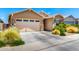 Charming single-story home with a two-car garage, desert landscaping and a neutral color scheme at 9624 E Thunderbolt Ave, Mesa, AZ 85212