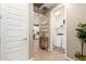 Bright hallway showcasing wood-look tile floors, connecting to a well-lit laundry room and modern kitchen at 9624 E Thunderbolt Ave, Mesa, AZ 85212