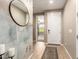 Open hallway with wood-look tile flooring, a round mirror and view into the living room at 9624 E Thunderbolt Ave, Mesa, AZ 85212