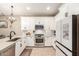 Modern kitchen features white cabinetry, stainless steel appliances, and a stylish faucet at 9624 E Thunderbolt Ave, Mesa, AZ 85212