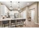 Open kitchen features a large center island, pendant lighting, stainless appliances, and white cabinets at 9624 E Thunderbolt Ave, Mesa, AZ 85212
