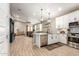 Open-concept kitchen with quartz counters, stainless steel appliances, and breakfast bar at 9624 E Thunderbolt Ave, Mesa, AZ 85212