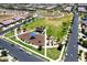 Overhead view of Gathering-friendly community park, including a playground, grassy areas, and seating, in a landscaped setting at 9624 E Thunderbolt Ave, Mesa, AZ 85212