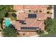 Birds-eye view of a tile roof home with solar panels, pool, trampoline, and lush desert landscaping at 9904 E South Bend Dr, Scottsdale, AZ 85255