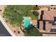 Stunning aerial view of a backyard featuring a sparkling pool and a trampoline on a lush green lawn at 9904 E South Bend Dr, Scottsdale, AZ 85255