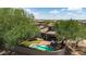 Aerial view of a home highlighting the backyard pool, patio, lawn, and landscaping, creating an outdoor oasis at 9904 E South Bend Dr, Scottsdale, AZ 85255