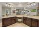 Elegant bathroom with dual sinks, granite countertops, and a vanity area with a plush stool at 9904 E South Bend Dr, Scottsdale, AZ 85255